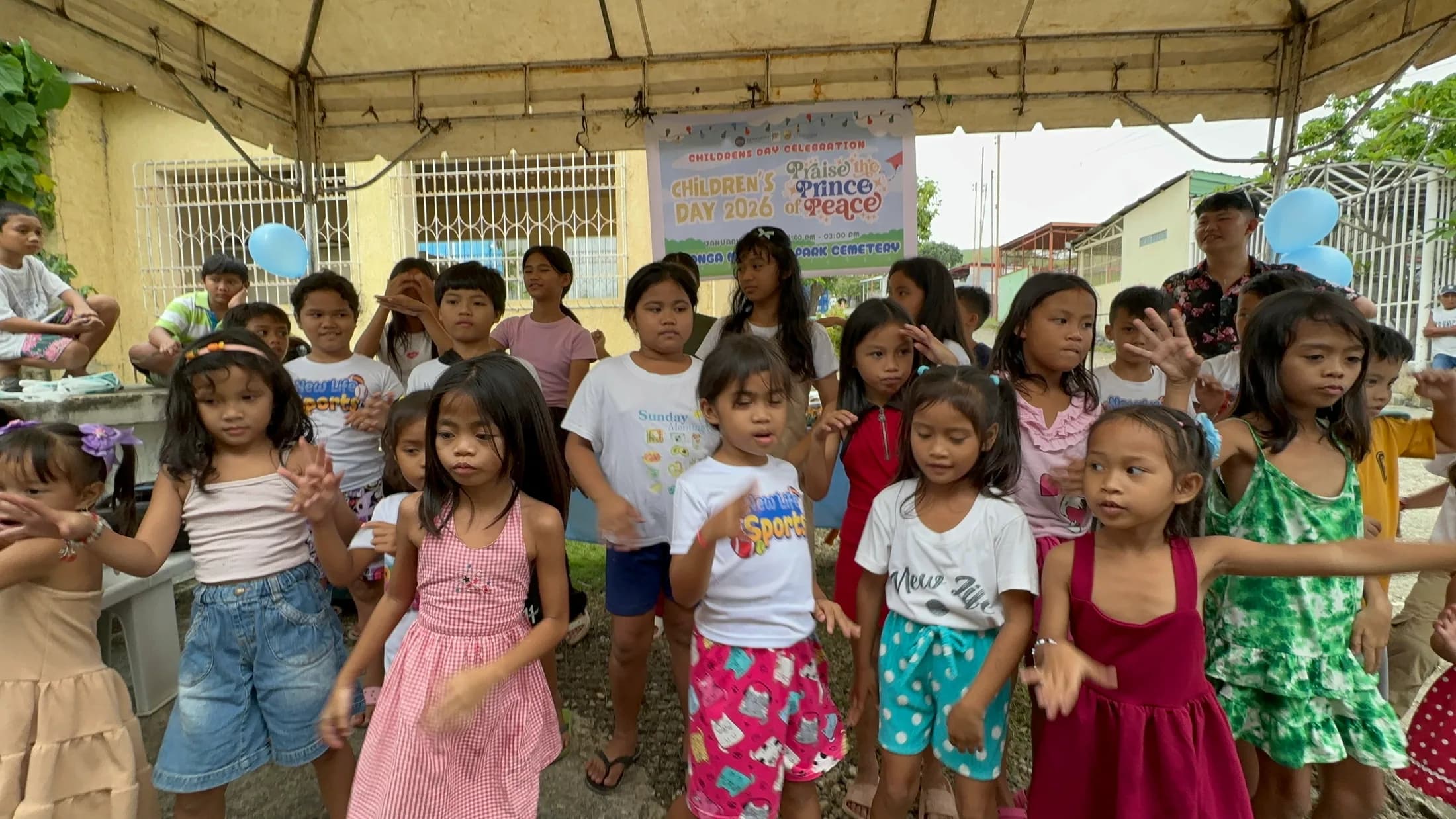 Children together beneath a tent at a celebration