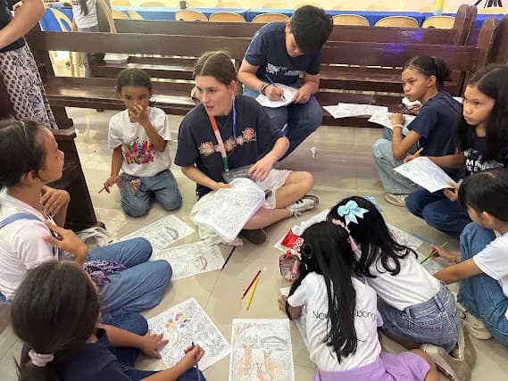 Children and adults reading together in a small circle