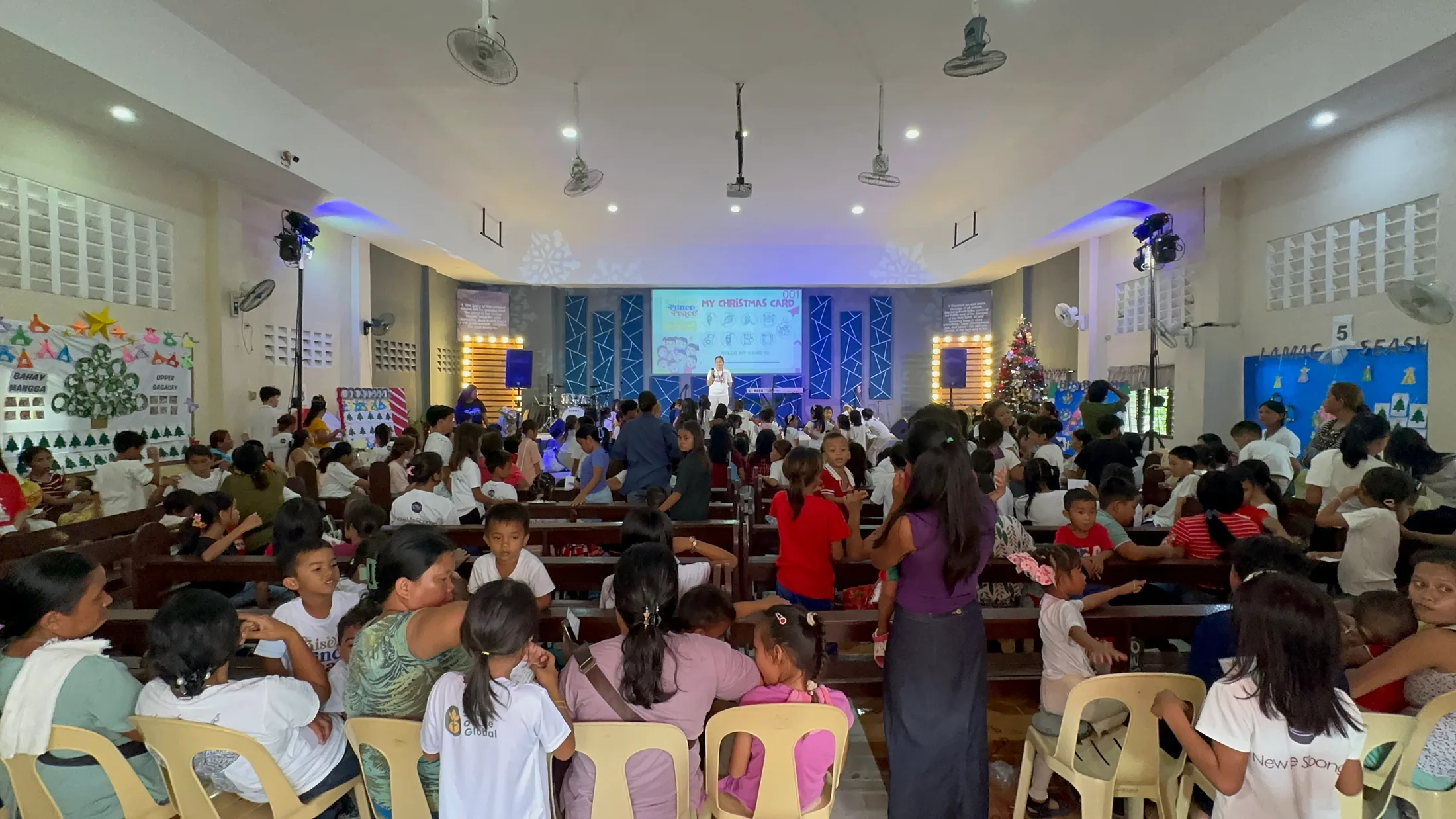 Families and children gathered in a hall