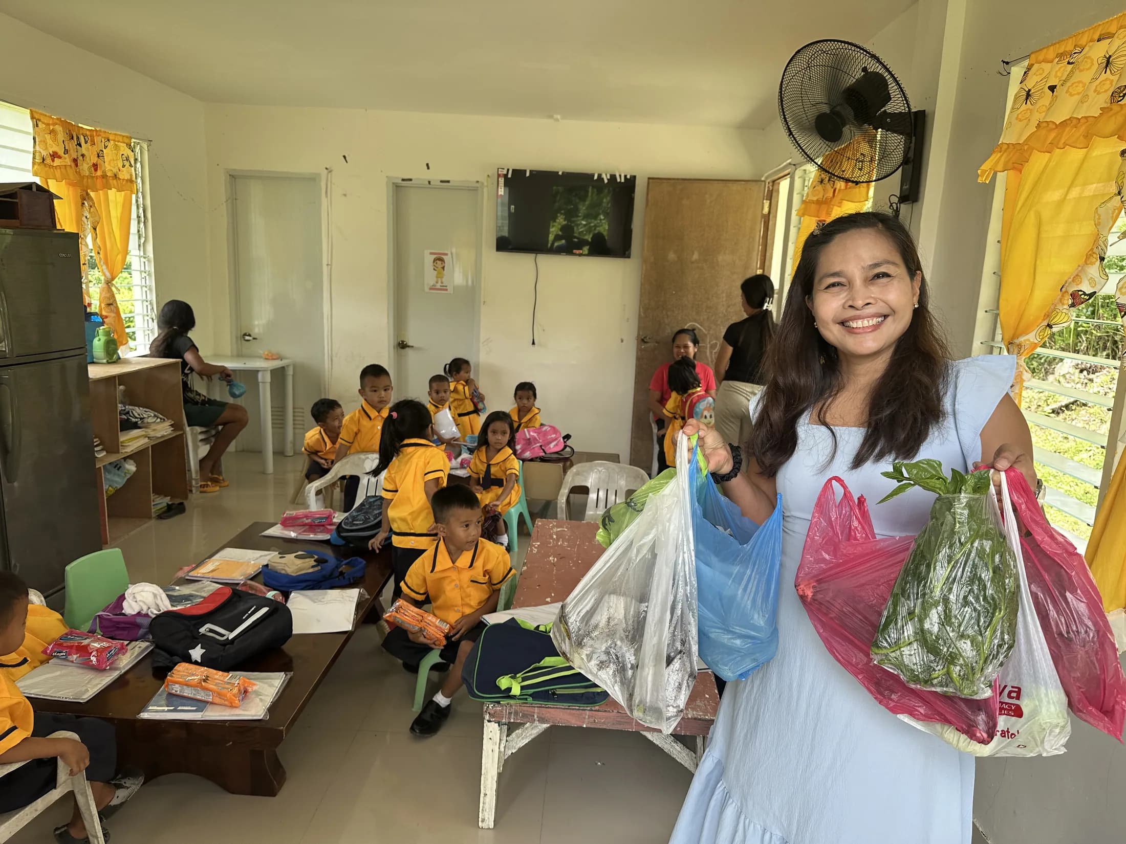 A community member sharing food with children