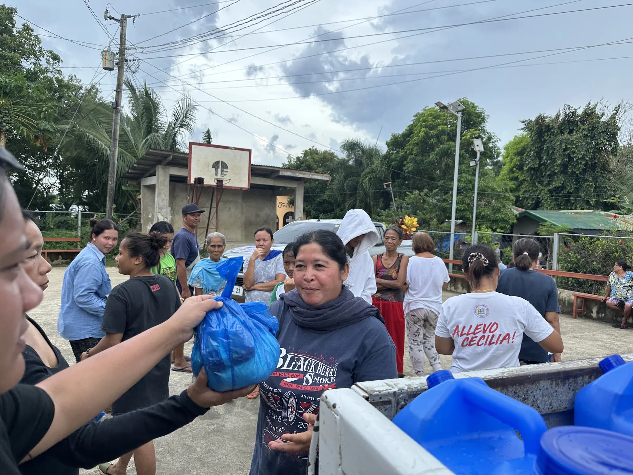 Community members sharing packed supplies outdoors