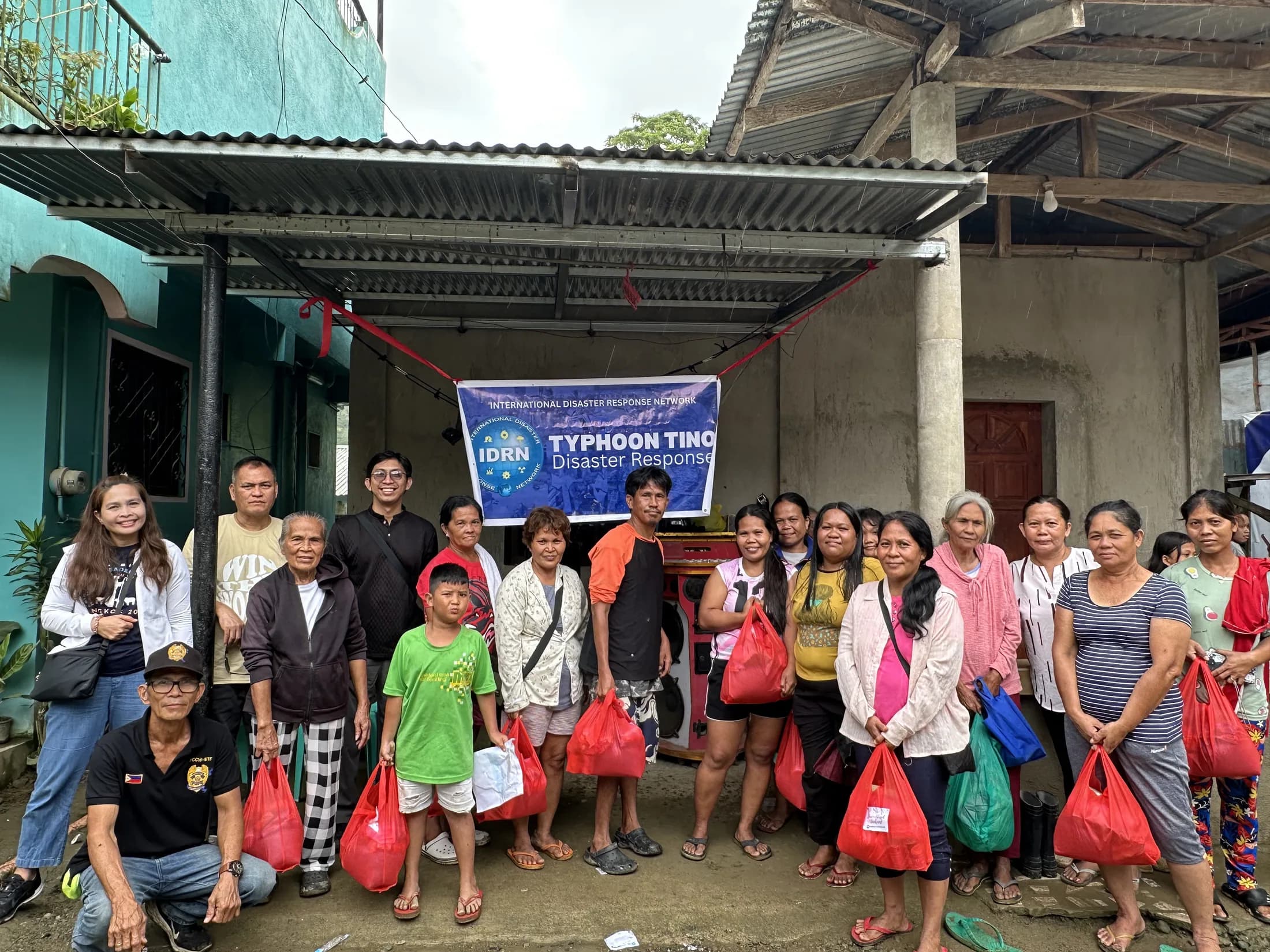 A group of adults posing together after a community relief activity