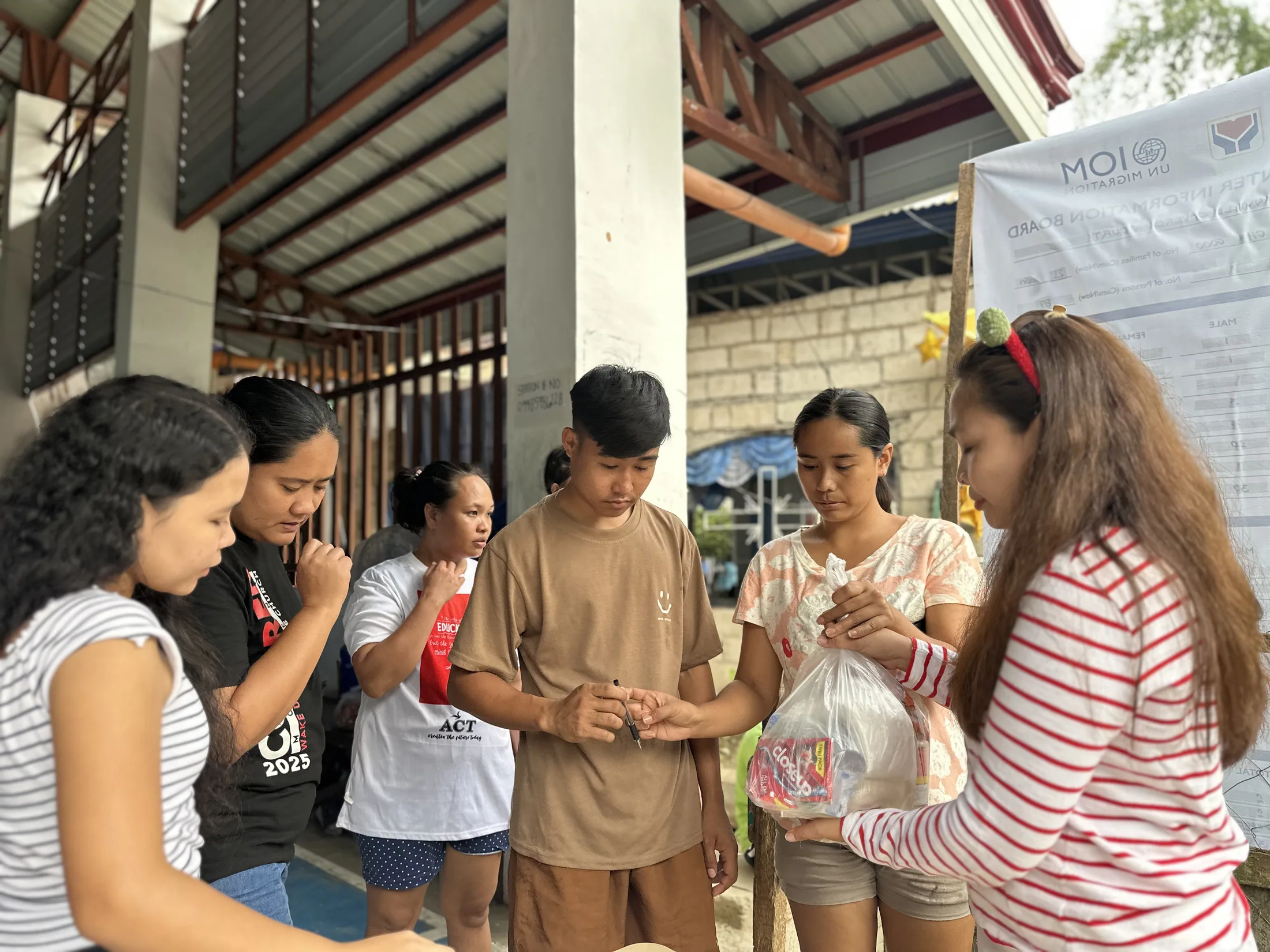 Adults packing bags of supplies together