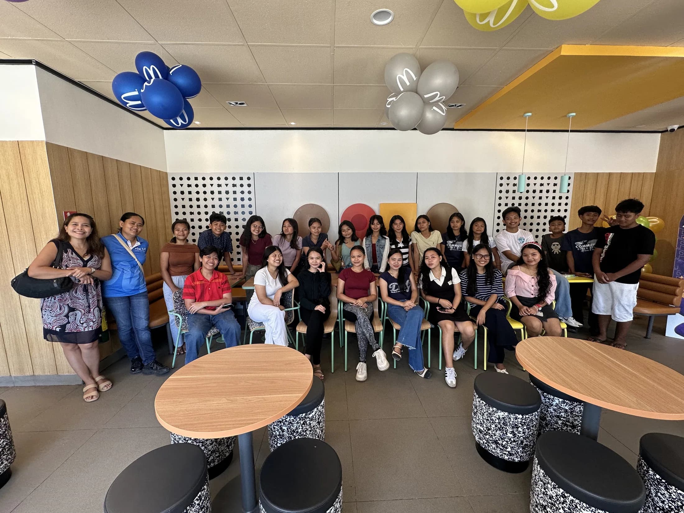 Adults and young people gathered together in a meeting room